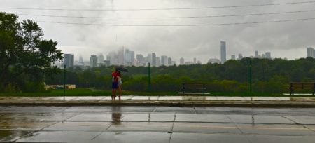 A couple in the rain enjoys the city views
