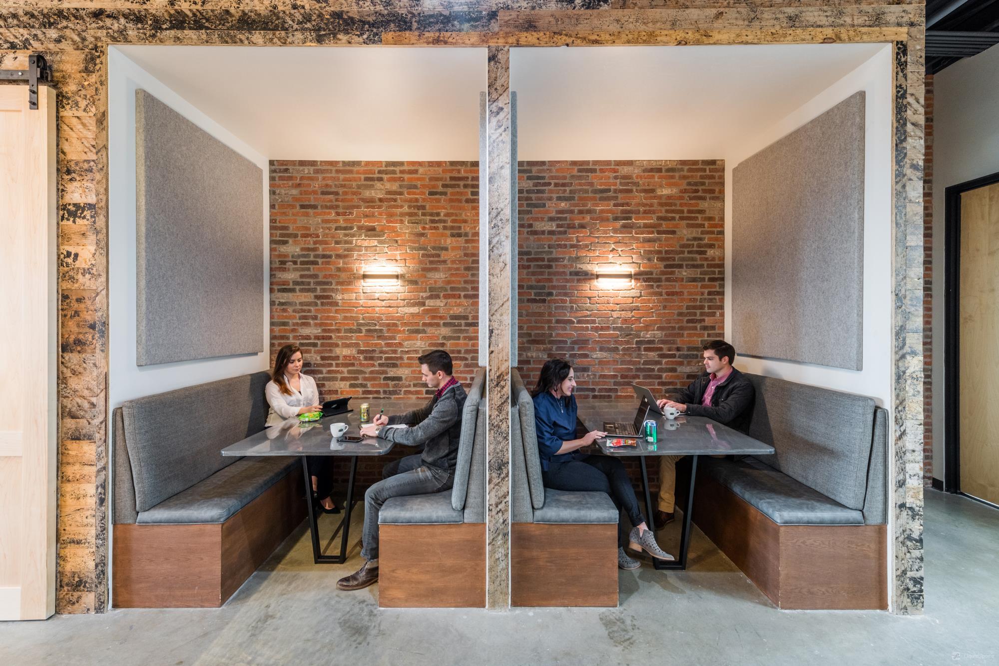 People coworking in booths