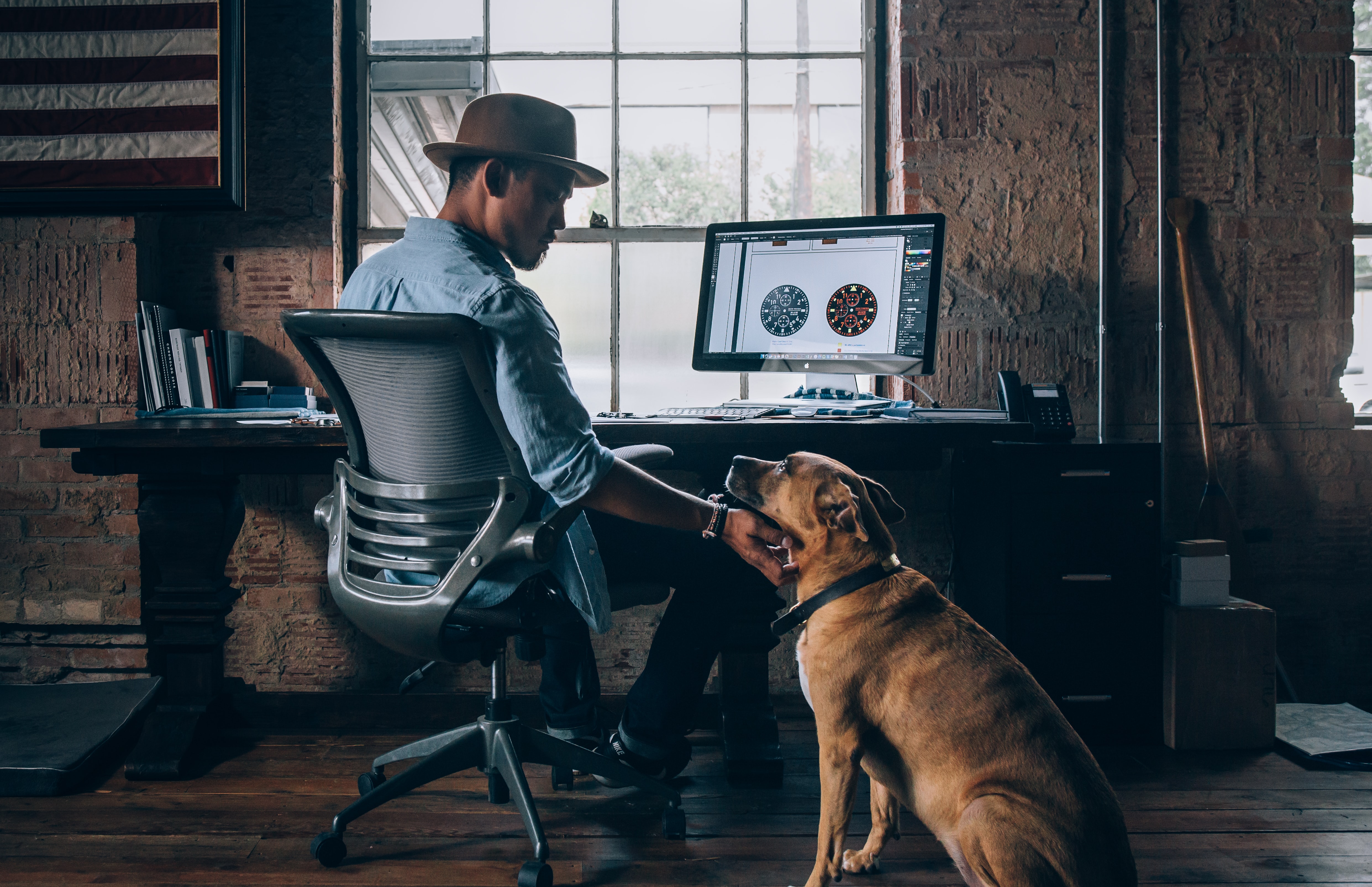 Image of person at a desk with a dog