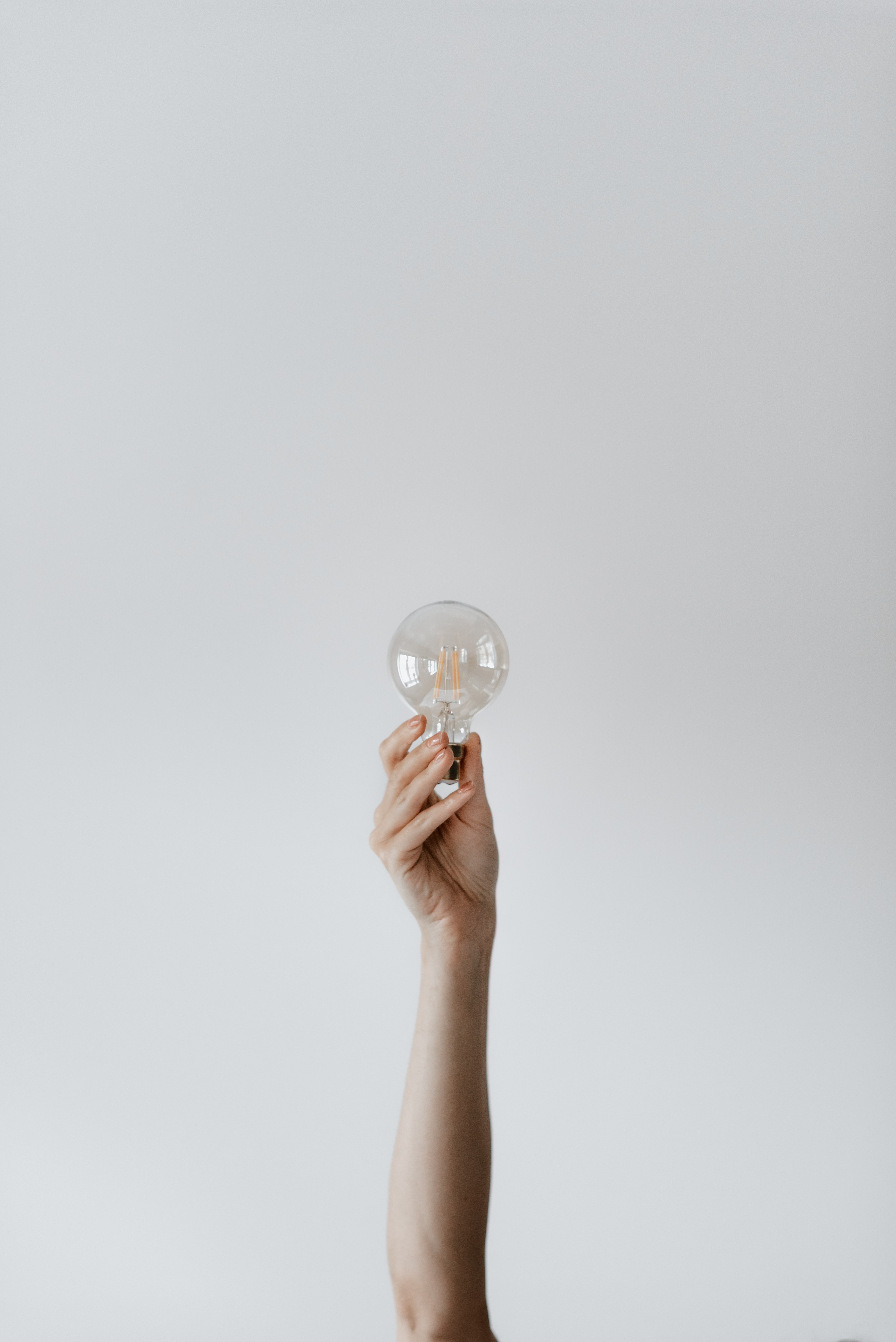Person holding a lightbulb